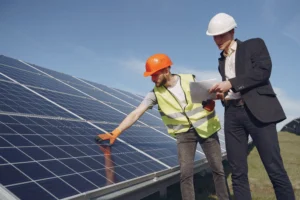 Commercial solar installation experts examining photovoltaic panels
