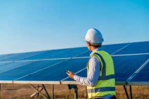 Technician checking a commercial solar system installation outdoors